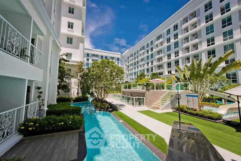 Luxurious condominium with pool and lush garden in modern residential complex.