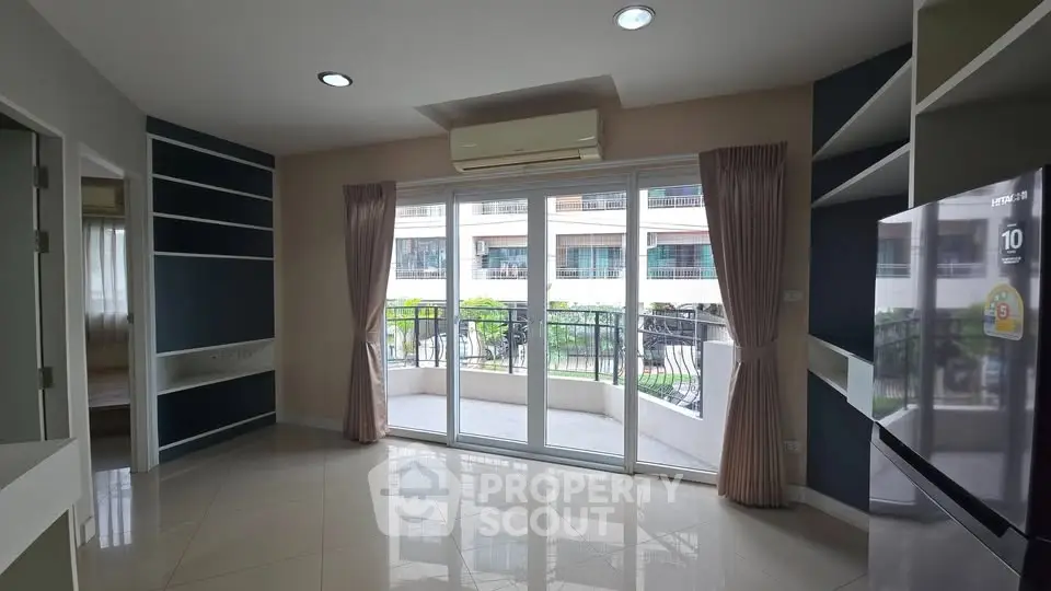 Modern living room with balcony view and sleek air conditioning unit