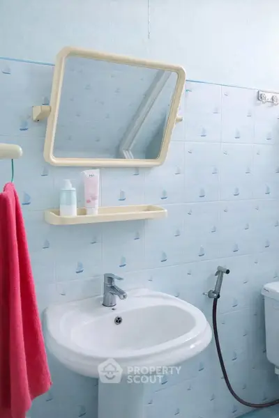 Charming bathroom with nautical-themed tiles and modern fixtures, perfect for a cozy home.