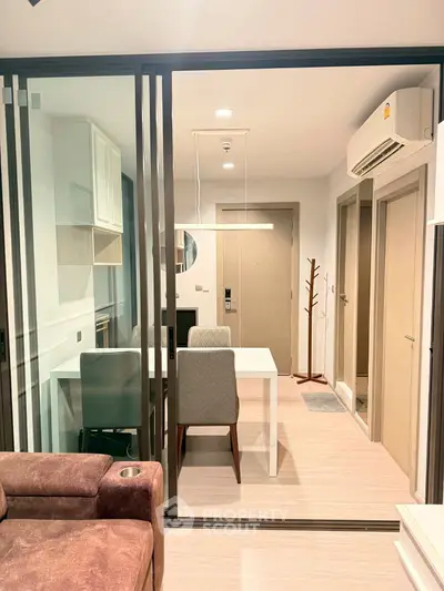 Modern apartment interior with open layout, featuring a cozy living area and dining space with stylish furniture.