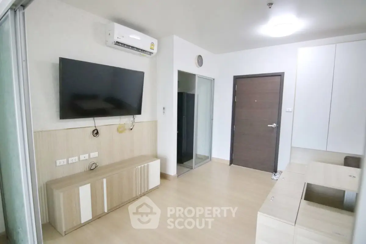 Modern living room with wall-mounted TV and sleek wooden furniture
