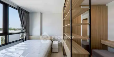 Modern bedroom with large windows and stylish wooden shelving unit