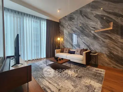 Luxurious modern living room with marble accent wall and elegant decor