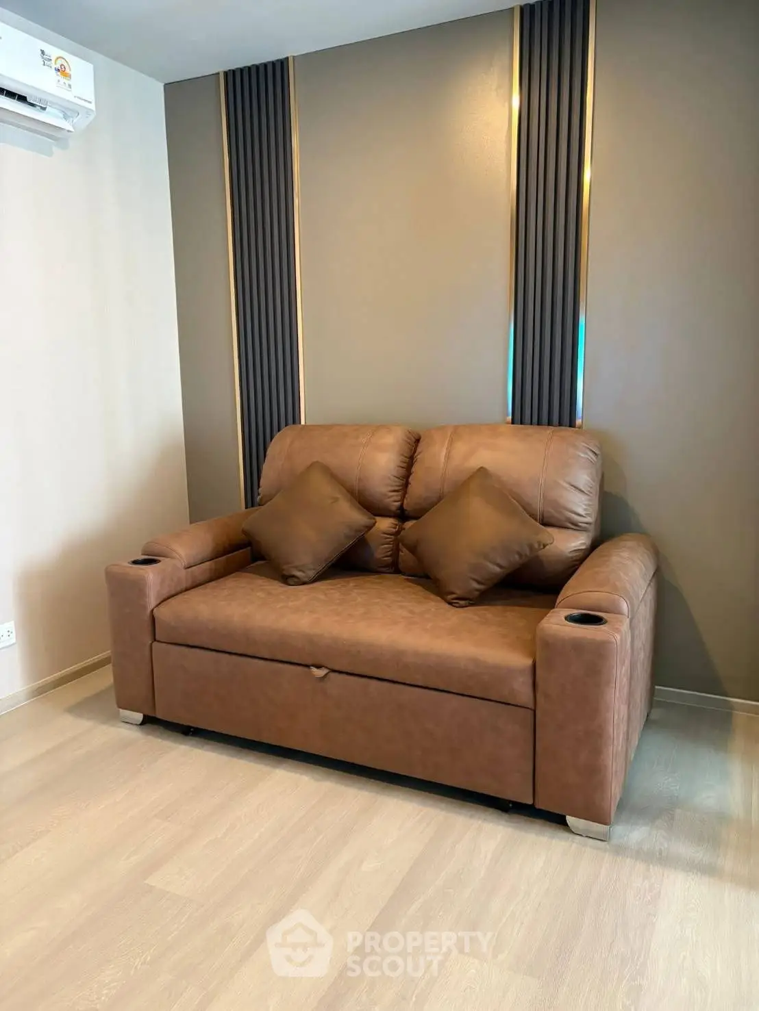 Modern living room with stylish brown leather sofa and elegant wall design