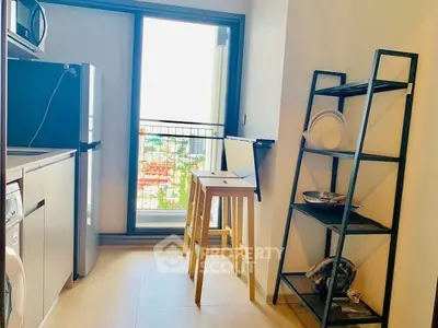 Modern kitchen with open layout and balcony view, featuring sleek appliances and stylish shelving.