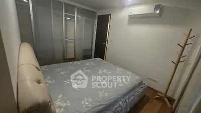 Cozy bedroom with modern wardrobe and air conditioning in a stylish apartment.