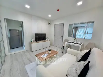 Modern living room with sleek furniture and open layout, featuring a cozy dining area and stylish decor.