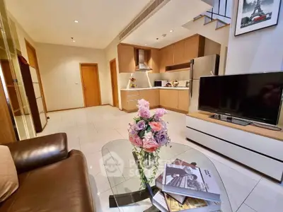 Modern open-plan living room with stylish kitchen and cozy seating area, perfect for urban living.