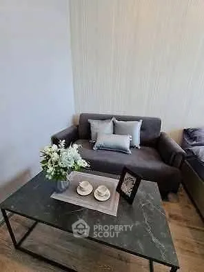 Modern living room with stylish sofa and elegant coffee table in a cozy apartment.