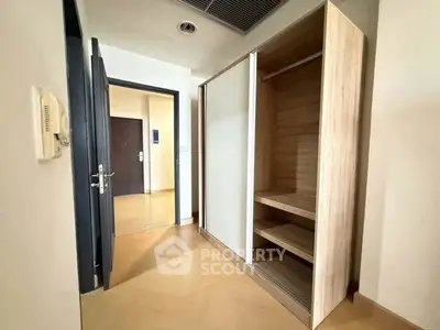 Spacious hallway with modern wooden storage unit and open door