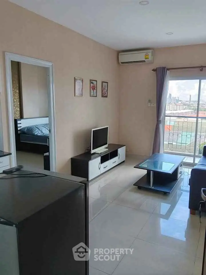 Modern living room with city view, sleek furniture, and air conditioning.