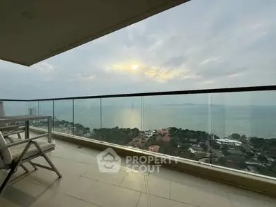 Stunning balcony view overlooking the ocean at sunset, perfect for relaxation.