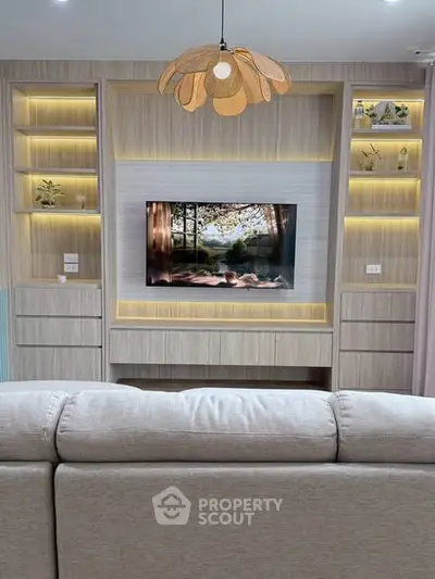 Modern living room with stylish built-in shelves and cozy lighting