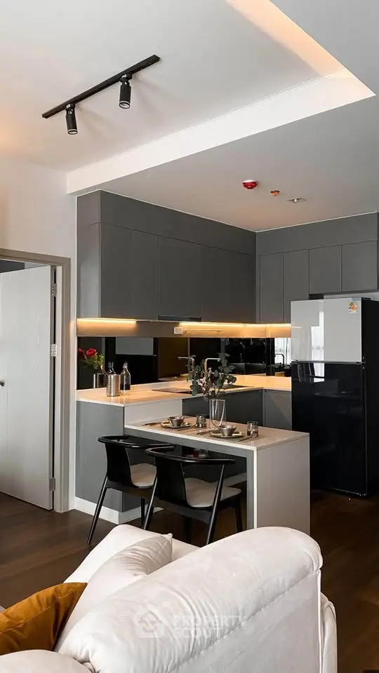 Modern kitchen with sleek design, featuring an open layout and stylish dining area, perfect for contemporary living.