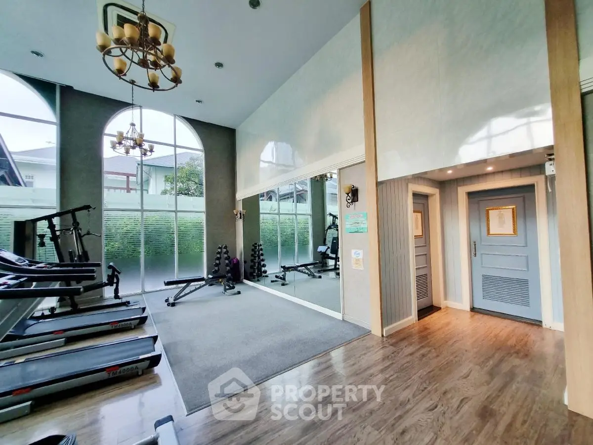 Modern home gym with large windows and exercise equipment