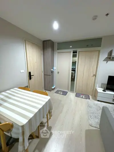 Modern living room with dining area and stylish decor in a cozy apartment.