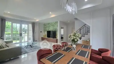 Spacious modern living room with elegant dining area and large windows offering garden views.