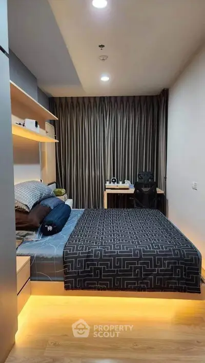 Modern bedroom with stylish decor and cozy lighting, featuring a comfortable bed and a functional study area.