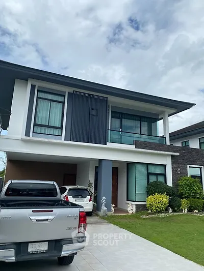 Modern two-story house with landscaped front yard and driveway parking.