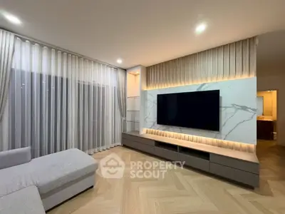 Modern living room with sleek TV setup and elegant lighting