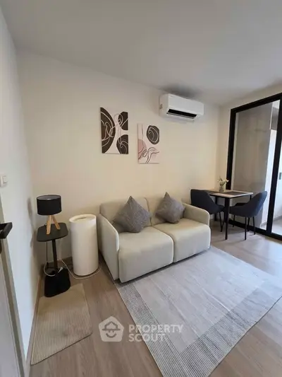 Modern living room with cozy sofa, stylish decor, and air conditioning in a bright apartment.