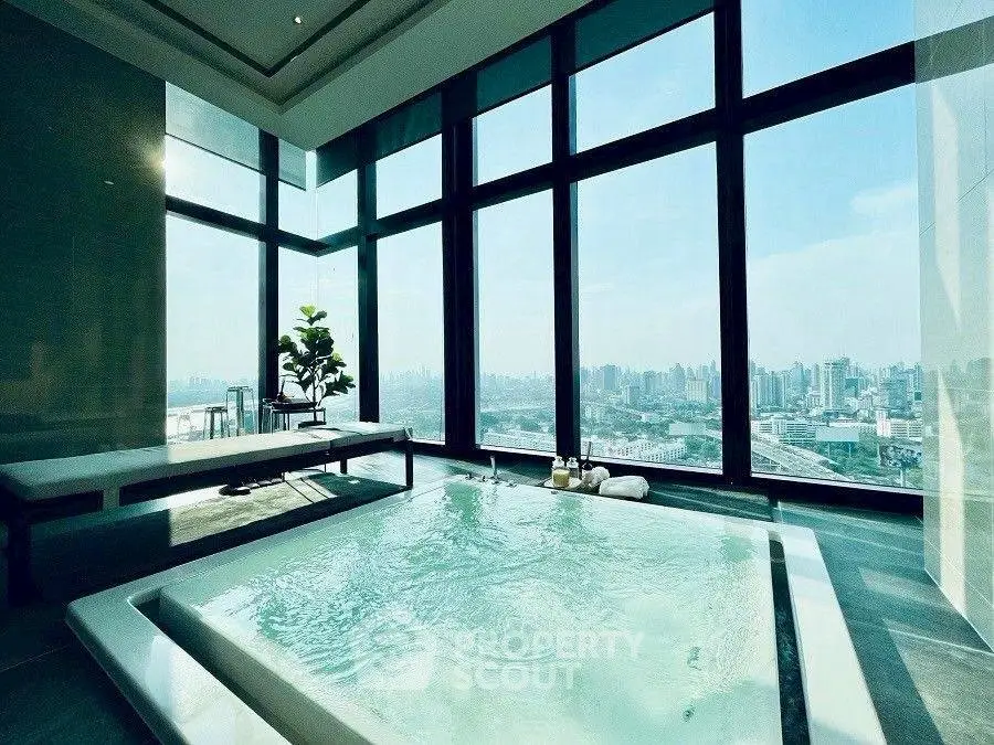 Luxurious indoor pool with stunning city skyline view from high-rise building.