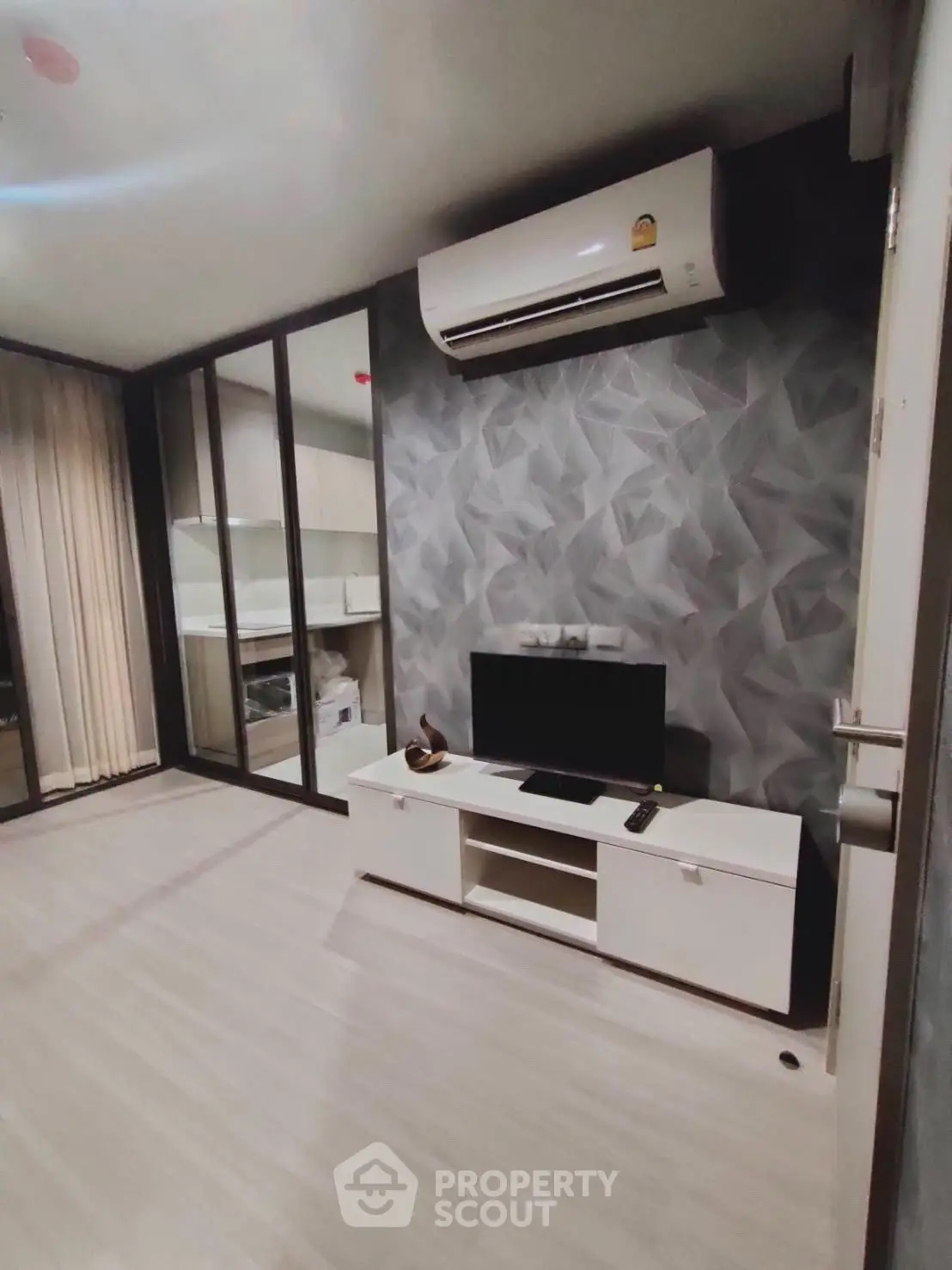 Modern living room with air conditioning and stylish geometric wall design