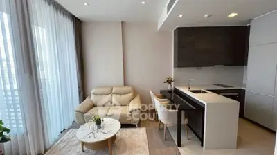 Modern living room with open kitchen and elegant furnishings