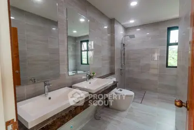 Luxurious modern bathroom with dual sinks and walk-in shower