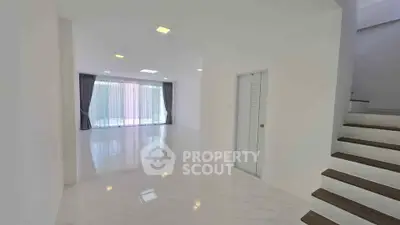 Spacious modern living room with glossy floors and large windows