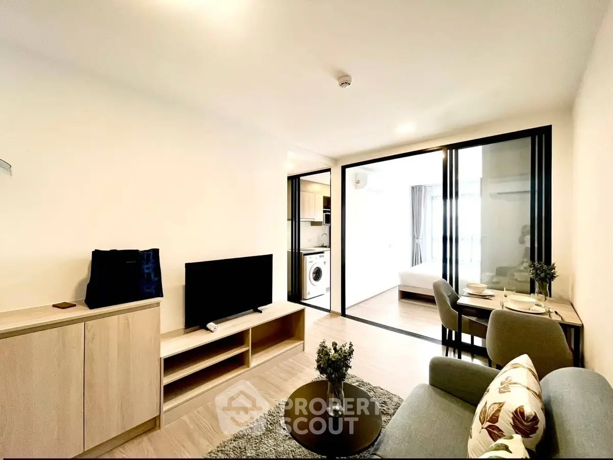 Modern living room with open layout, stylish furniture, and natural light in a contemporary apartment.