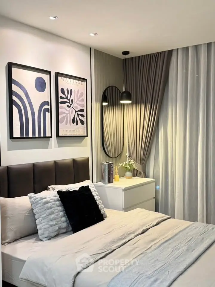 Modern bedroom with stylish decor and cozy ambiance, featuring elegant wall art and soft lighting.