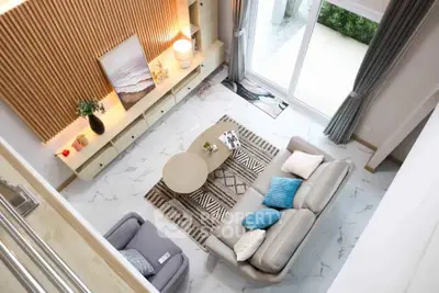 Modern living room with stylish decor and large windows offering natural light.