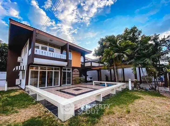 Stunning two-story home with spacious patio and lush garden, perfect for family living.