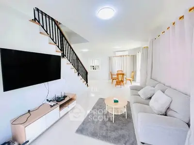 Spacious modern living room with sleek staircase and elegant decor