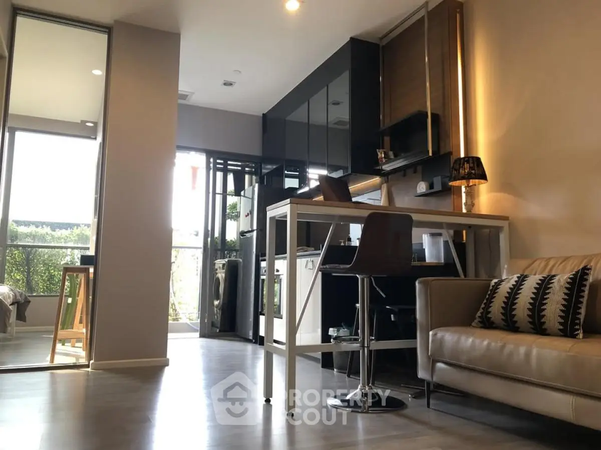 Modern open-plan living room with sleek kitchen and stylish decor