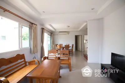 Spacious living room with wooden furniture and natural light