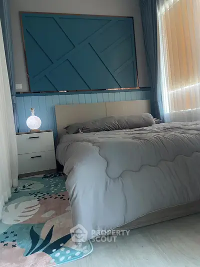 Cozy bedroom with modern decor and soft lighting, featuring a stylish bed and elegant nightstand.