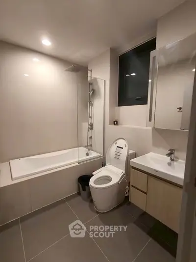 Modern bathroom with sleek fixtures and bathtub in contemporary apartment