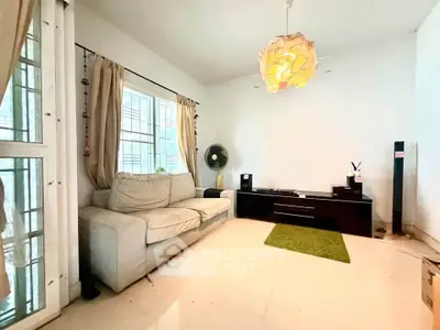 Spacious living room with modern decor and large windows for natural light.