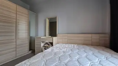 Modern bedroom with wooden furniture and comfortable mattress