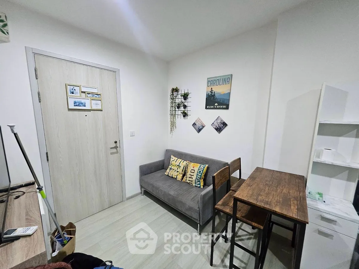 Cozy living room with modern decor and compact furniture, perfect for urban living.
