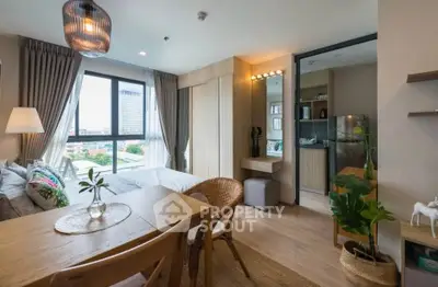 Modern studio apartment with open layout, featuring cozy dining area and stylish decor.