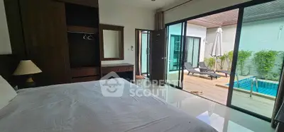Luxurious bedroom with poolside view and modern furnishings