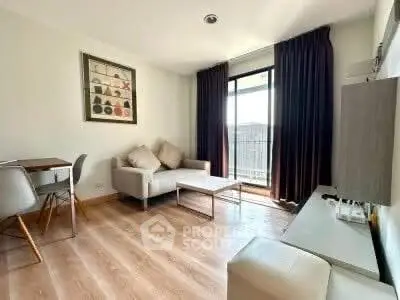 Modern living room with stylish decor and balcony access, featuring a cozy sofa and elegant dining area.