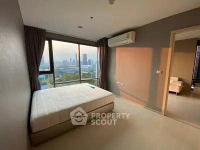 Spacious bedroom with city view and natural light in modern apartment