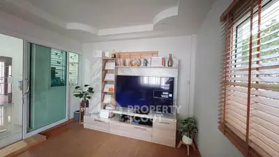 Modern living room with stylish TV unit and natural light
