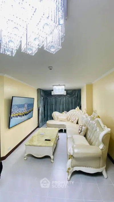 Luxurious living room with elegant chandelier and plush seating in a stylish interior.