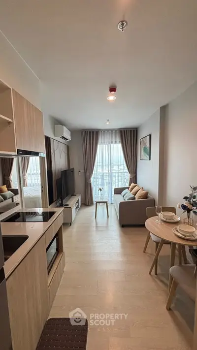 Modern living room with cozy seating and natural light in a stylish apartment.