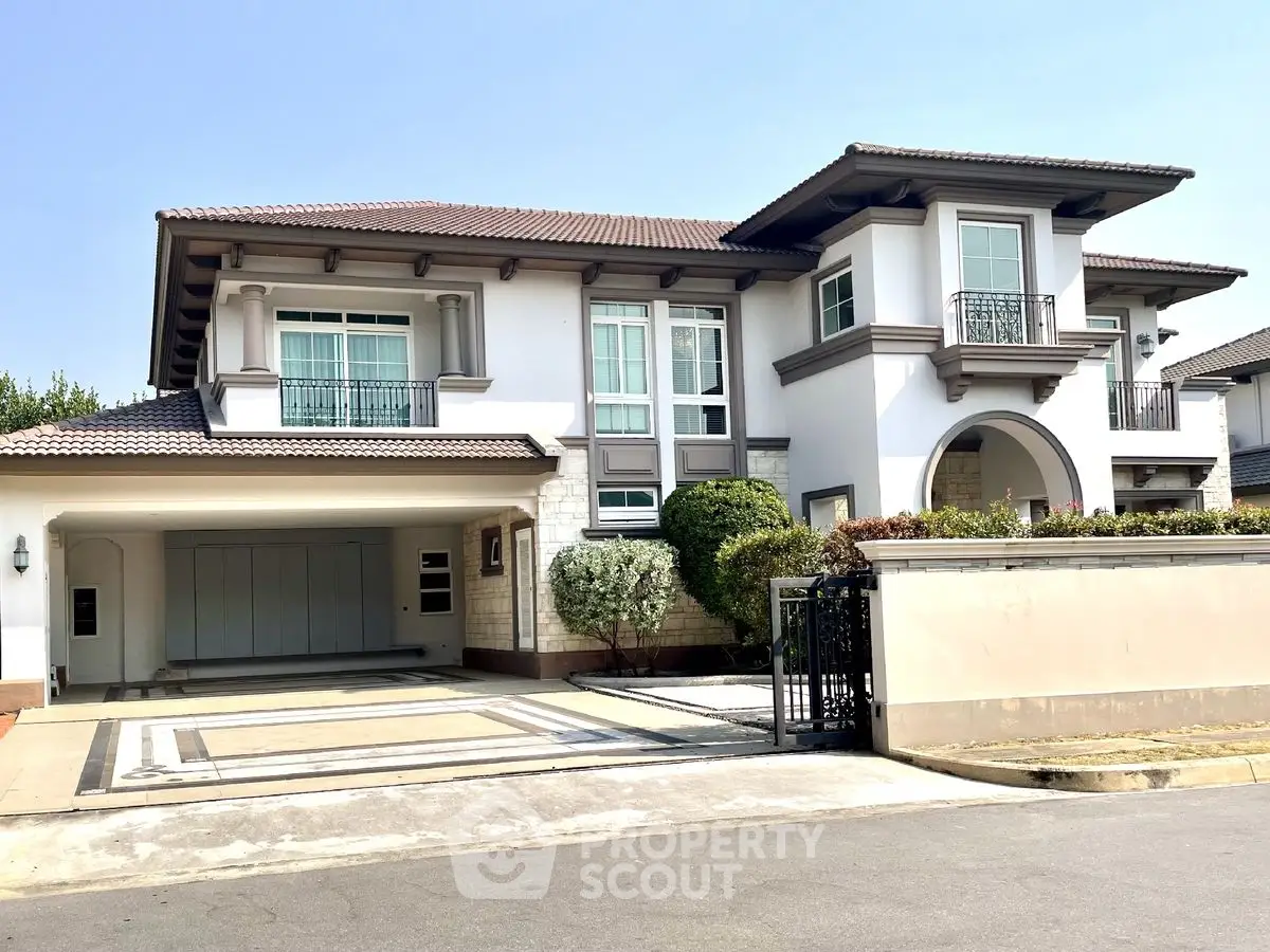 Luxurious two-story house with elegant facade and spacious driveway in a serene neighborhood.